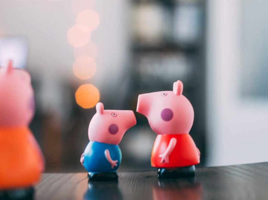 Peppa pig figurines on a table.