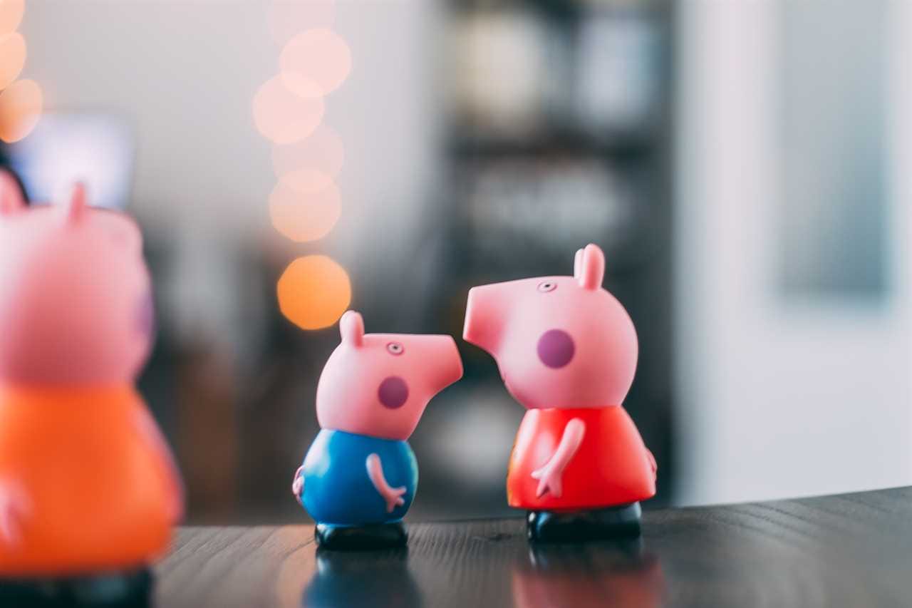 Peppa pig figurines on a table.