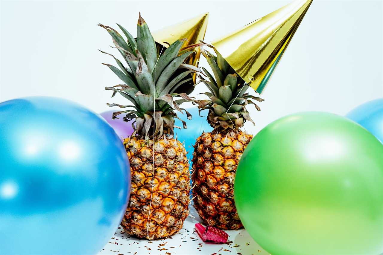 Pineapples and balloons on a white background.