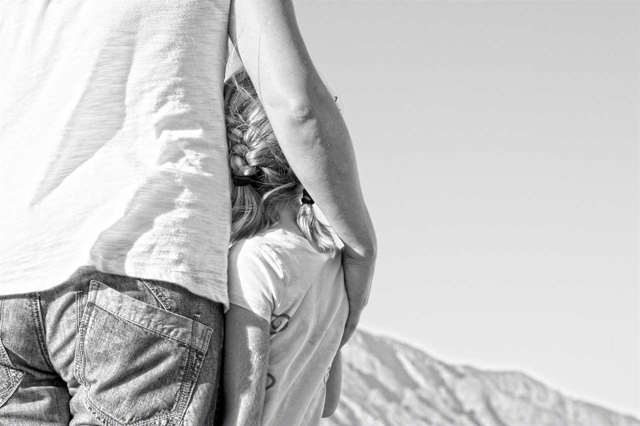 A black and white photo of a man and his daughter.