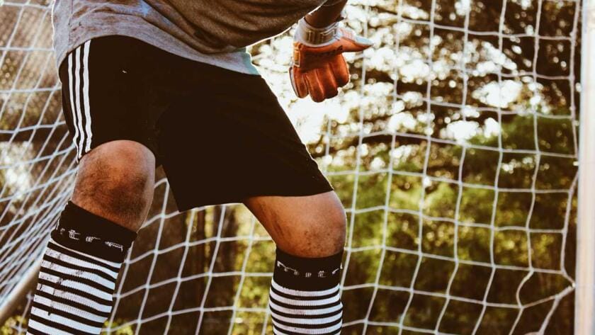 A young boy is preparing to kick a soccer ball.