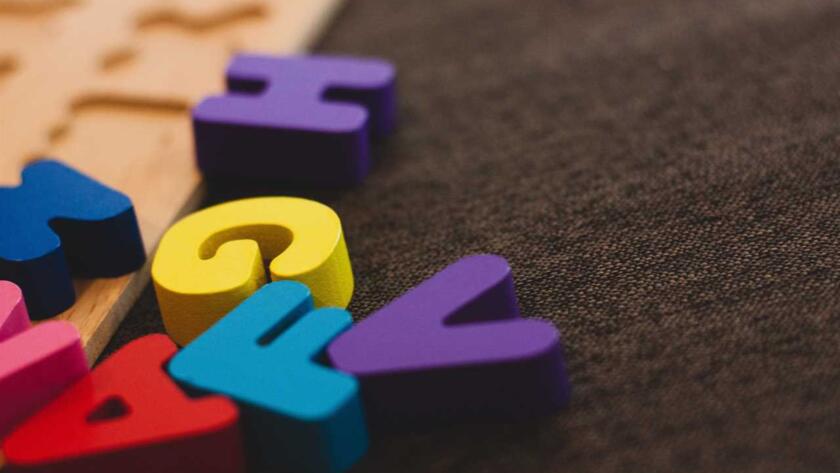 A set of colorful wooden letters on a table.