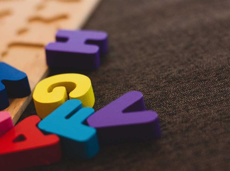 A set of colorful wooden letters on a table.