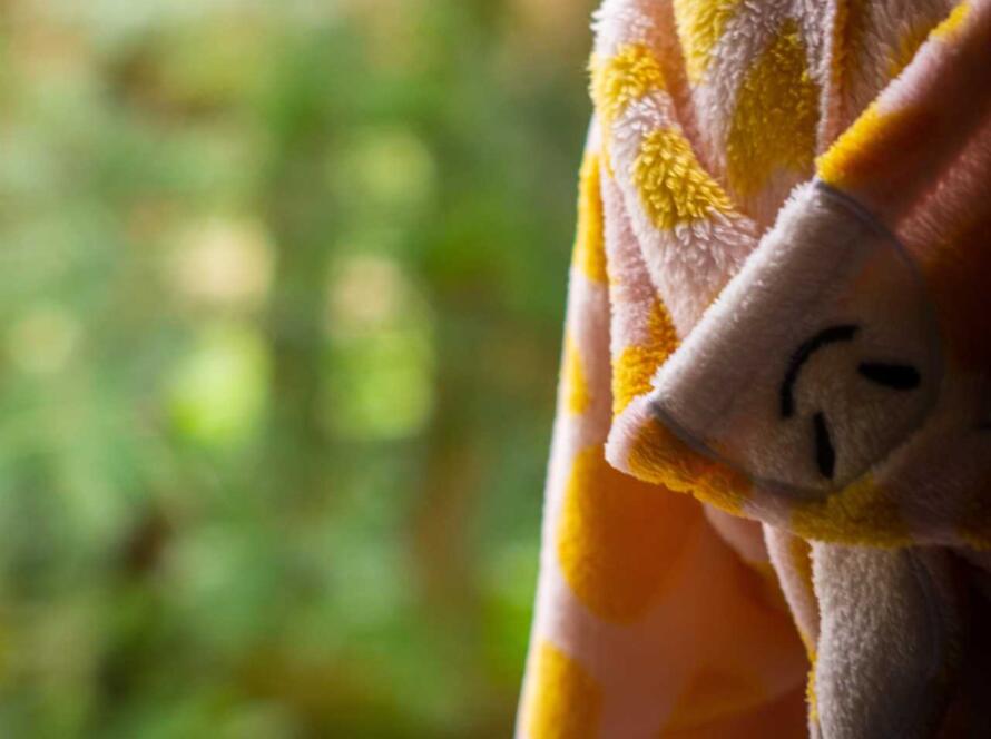 A child wearing a giraffe costume.